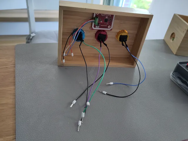 Inner side of the top of the DIY music box with the three physical buttons and the NFC reader