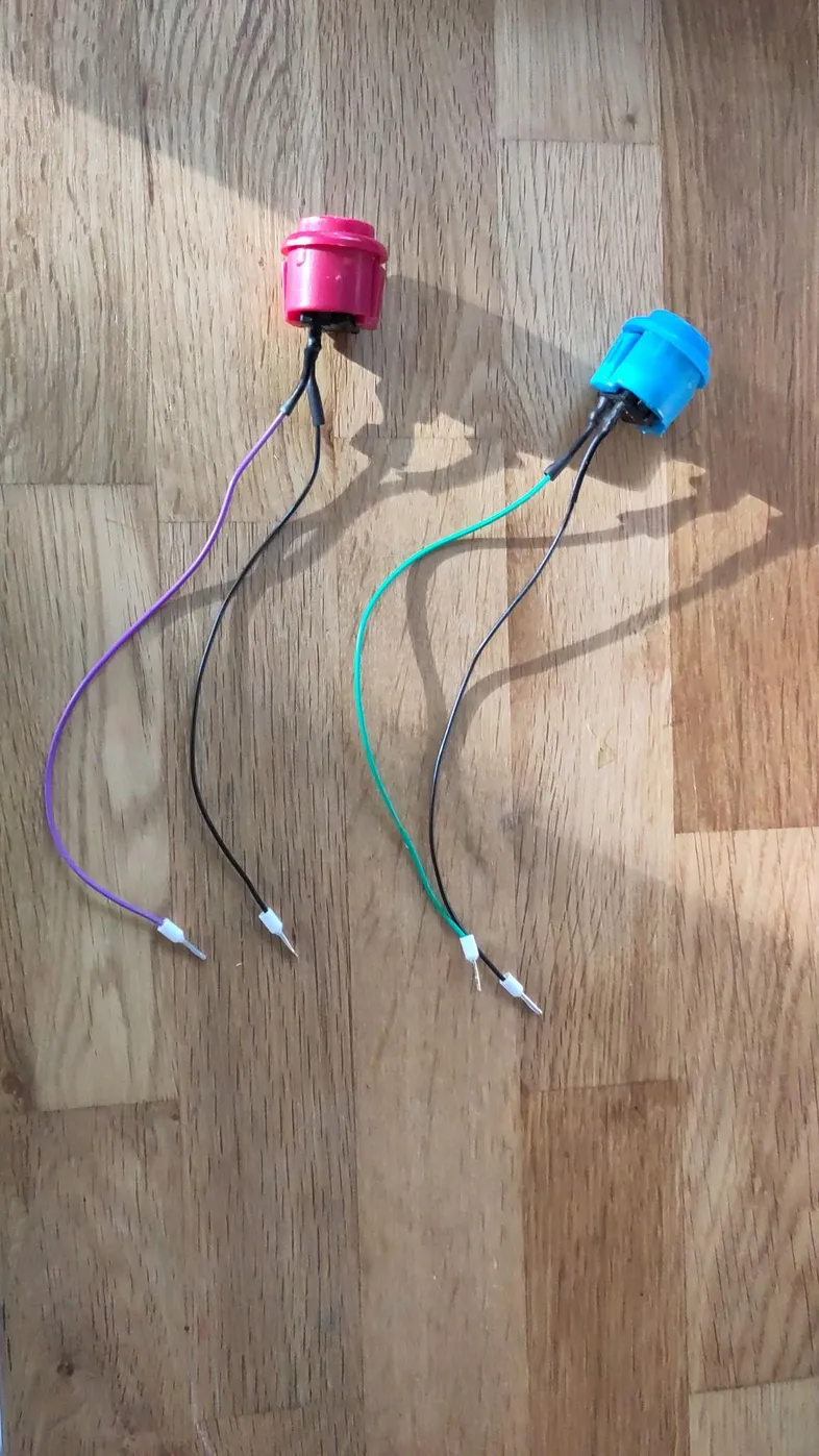 The buttons with soldered wires and cable end crimps